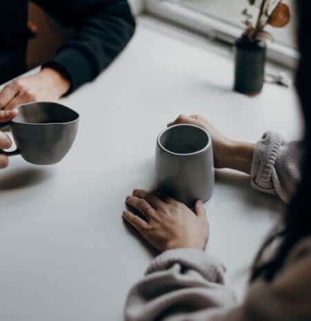 A man and a woman having coffee