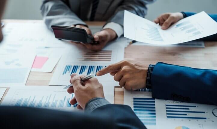 Business men sat looking at documents